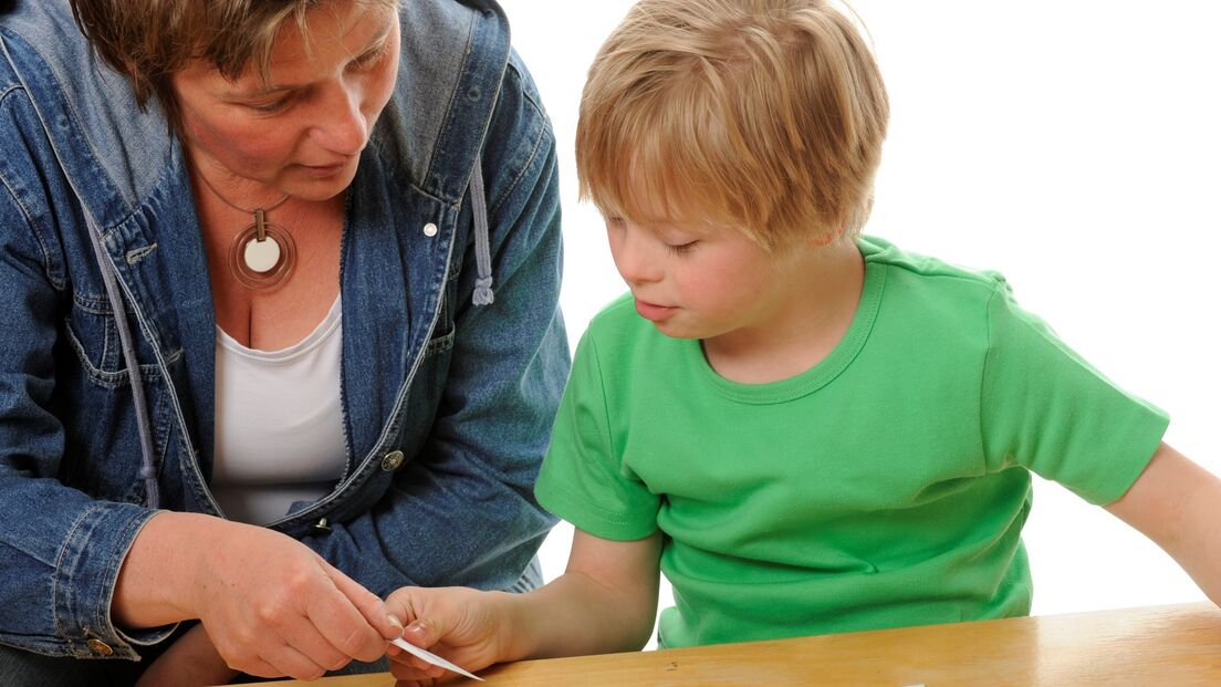 Boy working with therapist cards web