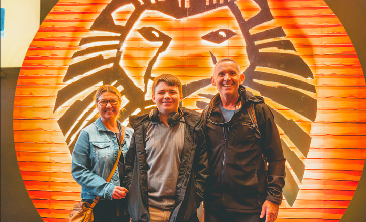 Fynn and his parents at the Lion King musical for Connection Day.