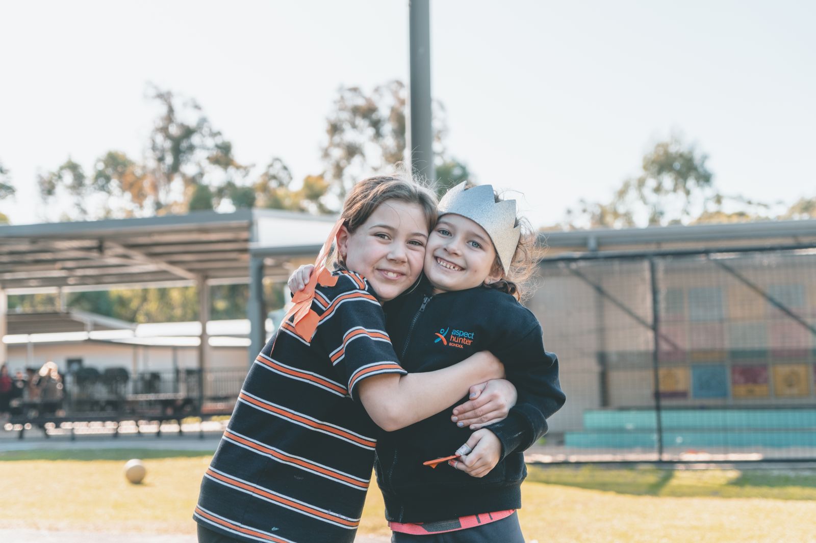 Students hugging in the playground