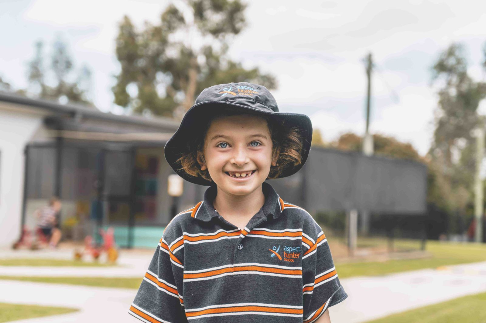 Student in school uniform enjoying playground space