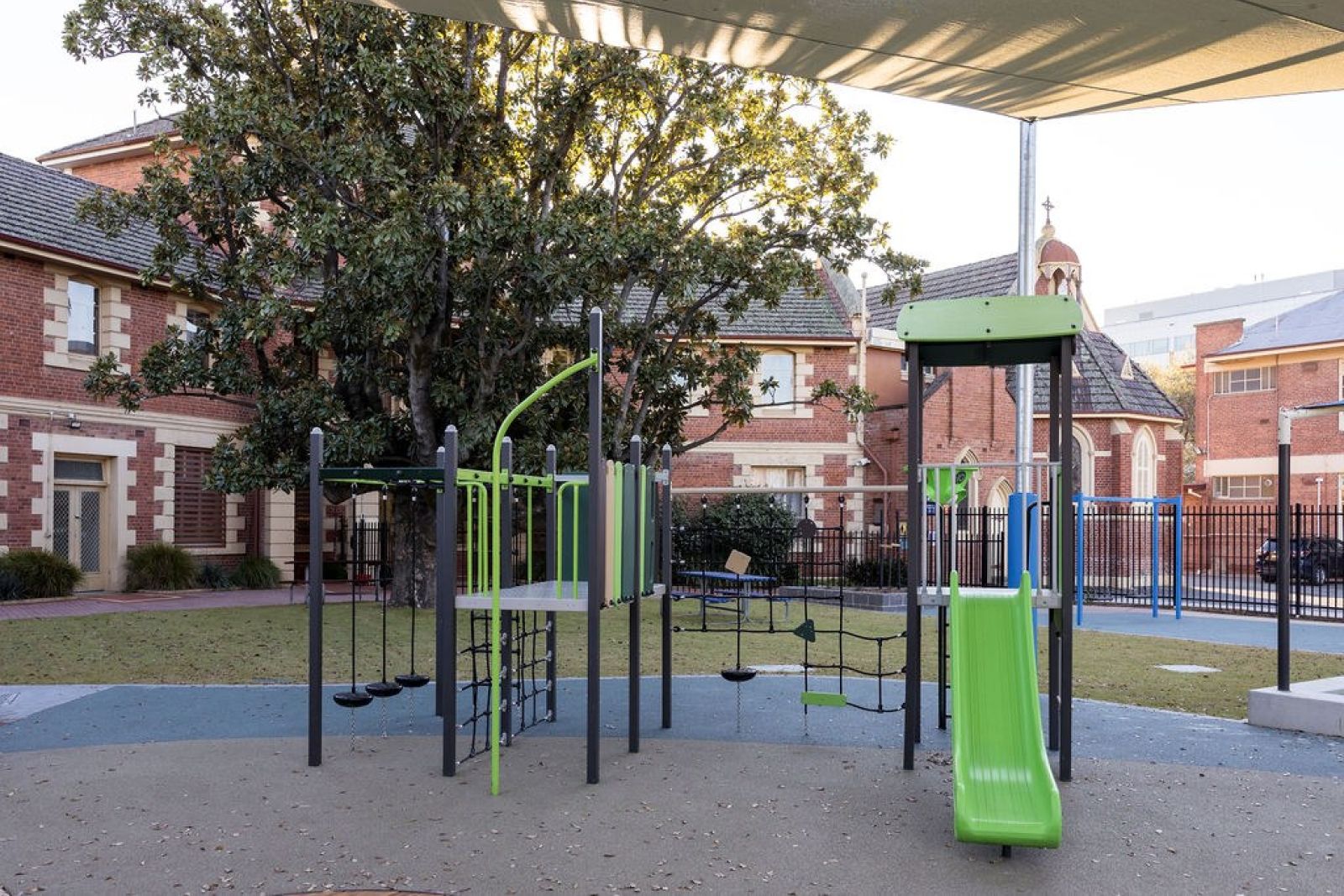 Outdoor playground area with accessible climbing structures and slide