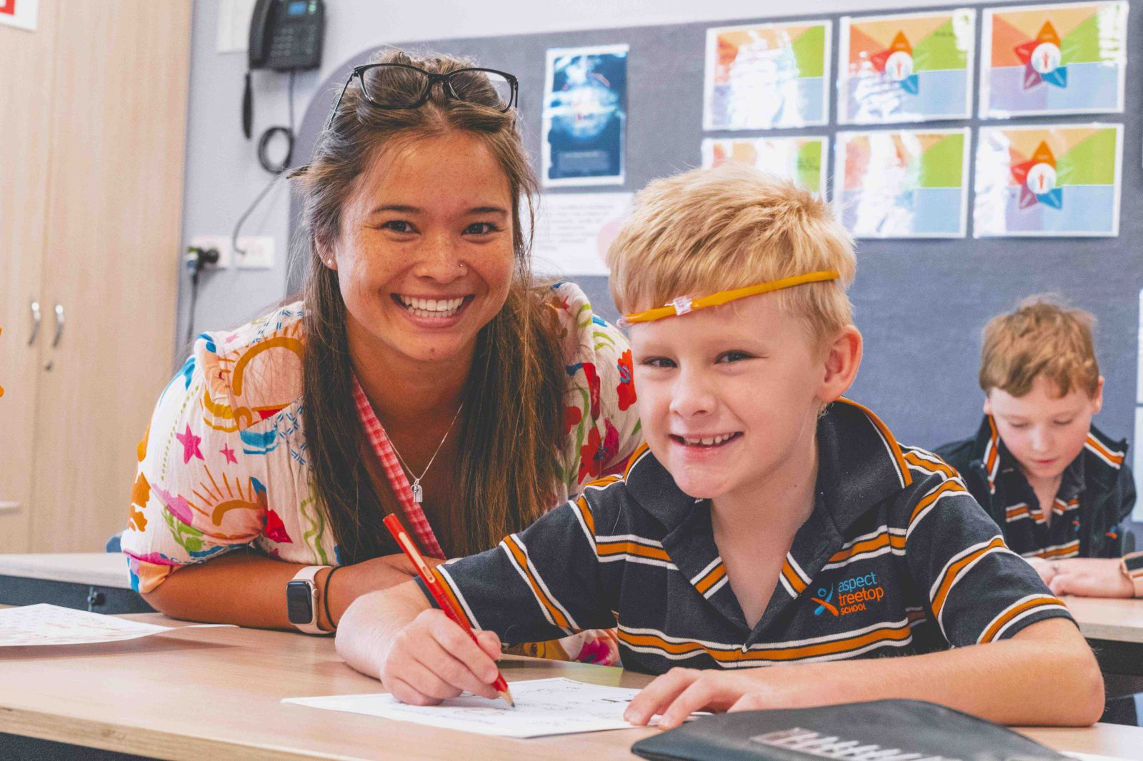 Teacher and student completing work together
