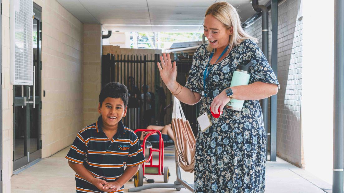 Student and teacher smiling