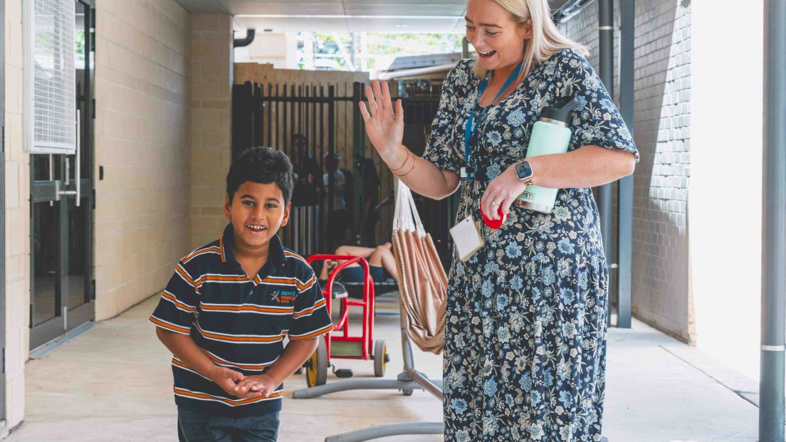 Student and teacher smiling
