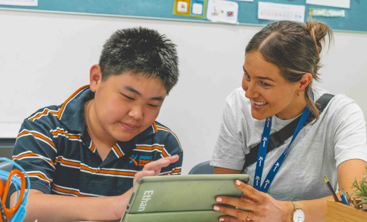 Student and teacher completing work on an Ipad