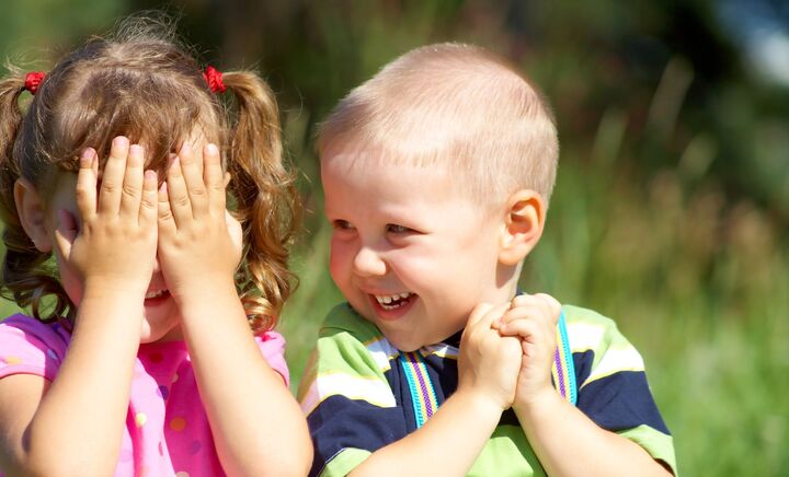 Boy and girl peek a boo web